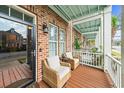 Relaxing covered balcony featuring comfortable seating, providing a serene outdoor living space at 2790 Howard Ave. # D, Myrtle Beach, SC 29577