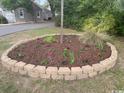 Close up of colorful flower garden with brick border enhancing curb appeal in front of property at 3904 Birchwood St., North Myrtle Beach, SC 29582
