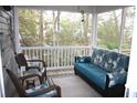 Inviting screened porch with wicker furniture, a blue sofa, and serene outdoor views at 3904 Birchwood St., North Myrtle Beach, SC 29582