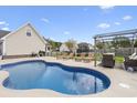 Backyard with an inviting pool, lounge chairs, patio furniture, and pergola offer great space for outdoor gatherings at 441 Garden Ave., Georgetown, SC 29440