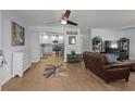 Open-concept living room with modern decor, showcasing wood floors and a seamless flow to the kitchen at 613 Cypress Dr., Surfside Beach, SC 29575