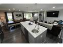 Kitchen island with sink, dining area and views into living room space at 710 62Nd Ave. N, Myrtle Beach, SC 29572