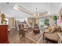 Elegant living room featuring an open layout, chandelier lighting, and access to outdoor area at 90 Carolina Crossing Blvd., Little River, SC 29566