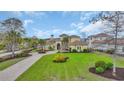 Expansive front lawn with a circular driveway, mature palm trees and lush landscaping at 9243 Marina Pkwy., Myrtle Beach, SC 29572