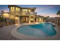 A luxurious outdoor living space showcasing a private pool, covered patio, and manicured landscaping at 9243 Marina Pkwy., Myrtle Beach, SC 29572
