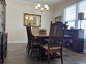 Traditional dining room boasts wood floors, complemented by classic wooden furniture and natural light at 1101 Bronwyn Circle, North Myrtle Beach, SC 29582
