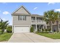 Charming two-story home with a balcony, attached garage, and a neatly maintained front lawn at 1101 Bronwyn Circle, North Myrtle Beach, SC 29582