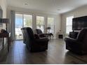 Inviting living room with wood-look tile flooring, comfortable seating, and sliding glass doors to the outside at 1101 Bronwyn Circle, North Myrtle Beach, SC 29582