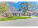Well-maintained single-story home with a pristine front lawn and paved driveway in a quiet neighborhood at 111 Hickory Dr., Conway, SC 29526