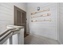 Hallway featuring coastal decor, including decorative oars hung on a white, wood-paneled wall at 12 Spartina Ct. # 2, Pawleys Island, SC 29585