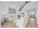 Bright living room boasts high ceilings, cozy sofas, light wood floors and beach-themed decorations at 12 Spartina Ct. # 2, Pawleys Island, SC 29585