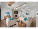 Bright living room with stone fireplace, hardwood floors, tray ceiling and stylish modern furnishings at 134 Avenue Of The Palms, Myrtle Beach, SC 29577