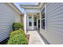 Cozy front porch framed by white pillars, siding and decorative windows at 1501 Palmina Loop # B, Myrtle Beach, SC 29588