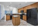 Open-concept kitchen featuring granite countertops, island, and modern black appliances at 1501 Palmina Loop # B, Myrtle Beach, SC 29588