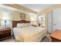 Inviting bedroom with a comfortable bed, soft lighting, and a doorway to the bathroom at 1604 N Ocean Blvd. # 904, Myrtle Beach, SC 29577
