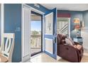 An open door leads from the living room to a balcony with a peaceful view at 1801 N Ocean Blvd. # O-4, North Myrtle Beach, SC 29582
