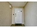 Well-lit entrance features a secure white door with a textured wall and secure entry system at 2151 Bridge View Ct. # 1-702, North Myrtle Beach, SC 29582