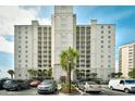 Condo building featuring multiple balconies, well-maintained landscaping, and convenient parking for residents at 2151 Bridge View Ct. # 1-702, North Myrtle Beach, SC 29582
