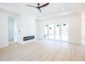 Bright living room featuring modern floors, a tray ceiling, a ceiling fan and sliding glass doors at 232 Ole Maple St., Loris, SC 29569