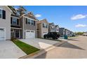Beautiful view of the neighborhood streetscape with townhomes and attached garages at 247 Christiana Ln. # D, Myrtle Beach, SC 29579