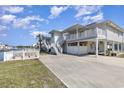 Charming two-story home with a balcony, outdoor storage, and ample parking space at 301 58Th Ave. N, North Myrtle Beach, SC 29582