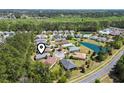 This aerial view highlights a community with homes, trees, and a pond at 320 Cog Hill Ct., Murrells Inlet, SC 29576