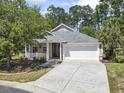 Charming single-story home featuring a two-car garage, front porch and well-manicured lawn at 320 Cog Hill Ct., Murrells Inlet, SC 29576