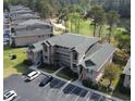 Condo building aerial view with golf course and pond in the background, and ample parking at 524 Pinehurst Ln. # 19D, Pawleys Island, SC 29585