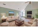 Cozy living room features a fireplace, vaulted ceiling, and comfortable seating arrangement at 5525 Springs Ave., Myrtle Beach, SC 29577