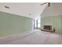Spacious living room boasts a vaulted ceiling, fireplace, and sliding glass doors at 5525 Springs Ave., Myrtle Beach, SC 29577