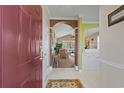 Inviting home entryway with tile floors, arched doorways, and views into the bright living room with vaulted ceiling at 5751 Oyster Catcher Dr. # 234, North Myrtle Beach, SC 29582