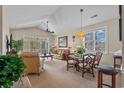 Bright living room featuring a dining area, vaulted ceilings, and sliding glass doors to the outdoor patio at 5751 Oyster Catcher Dr. # 234, North Myrtle Beach, SC 29582