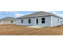 The backyard has light blue vinyl siding, good windows, and a small cement patio at 620 Culmen Ct., Myrtle Beach, SC 29588