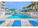 Community swimming pool and lounge area surrounded by well-maintained landscaping at 625 N Waccamaw Dr. # 301, Murrells Inlet, SC 29576