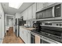 Efficient kitchen with black appliances and sleek white cabinets for a clean look at 6804 N Ocean Blvd. # 1127, Myrtle Beach, SC 29572