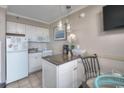 Functional kitchenette with mini-fridge, microwave, and breakfast bar, perfect for quick meals at 6900 N Ocean Blvd. # 1505, Myrtle Beach, SC 29572