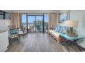Relaxing living room with sleeper sofa and a balcony overlooking the ocean, ideal for vacation living at 6900 N Ocean Blvd. # 1505, Myrtle Beach, SC 29572