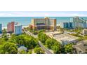 A high angle view of the resort buildings, a large parking lot, roads, and the distant beach at 6900 N Ocean Blvd. # 735, Myrtle Beach, SC 29572