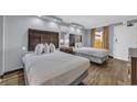 A well-lit bedroom featuring two beds, nightstand, lamps, and a mirror at 6900 N Ocean Blvd. # 735, Myrtle Beach, SC 29572