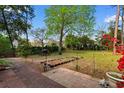 Spacious backyard with brick patio, garden beds, and lush greenery, ideal for outdoor activities at 708 48Th Ave. N, Myrtle Beach, SC 29577