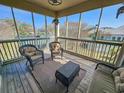 Enjoy the cozy screened patio with comfortable wicker seating and tennis court views at 800 Castleford Circle # 1-E, Myrtle Beach, SC 29572