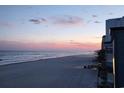 Panoramic ocean view during sunset showing buildings and sandy beach at 9540 Shore Dr. # 3-H, Myrtle Beach, SC 29572