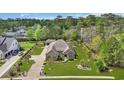 An aerial view of a single story brick home with a well manicured lawn, driveway and landscaping at 152 Creek Harbour Circle, Murrells Inlet, SC 29576