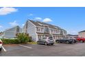 View of the condo complex showing the building, landscaping, and ample parking available at 1851 Colony Dr. # 6J, Myrtle Beach, SC 29575