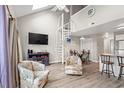 Bright living room featuring vaulted ceilings, a spiral staircase, and modern décor at 1851 Colony Dr. # 6J, Myrtle Beach, SC 29575