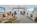 Bright living room features coastal decor, comfortable seating, and access to outdoor balcony at 202 56Th Ave. N, North Myrtle Beach, SC 29582