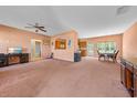 Spacious living room showcasing a kitchen pass-through, ceiling fan, and natural light at 270 Moulton Dr., Longs, SC 29568