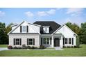Charming two-story home with a brick facade, white siding, black shutters and manicured lawn at 346 Ridge Rd., Galivants Ferry, SC 29544