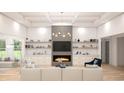 Bright living room featuring a modern fireplace, built-in shelving and plush white sofas at 346 Ridge Rd., Galivants Ferry, SC 29544