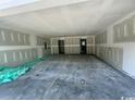 Large, unfinished garage with concrete floors and drywall, offering ample space and potential at 384 William Nobles Rd., Aynor, SC 29511